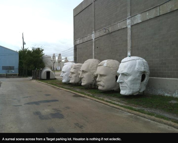 Statue heads across from a Target parking lot in Houston