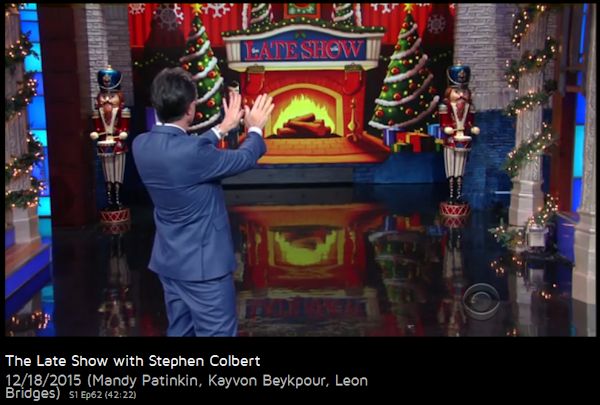 Stephen Colbert warming hands with virtual fire