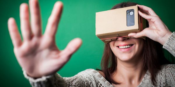 Woman using cardboard VR headset