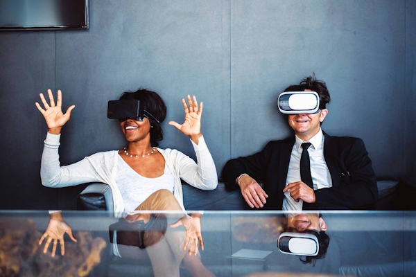 Woman and man wearing VR headsets