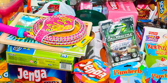 A pile of games, candy and toys for young children